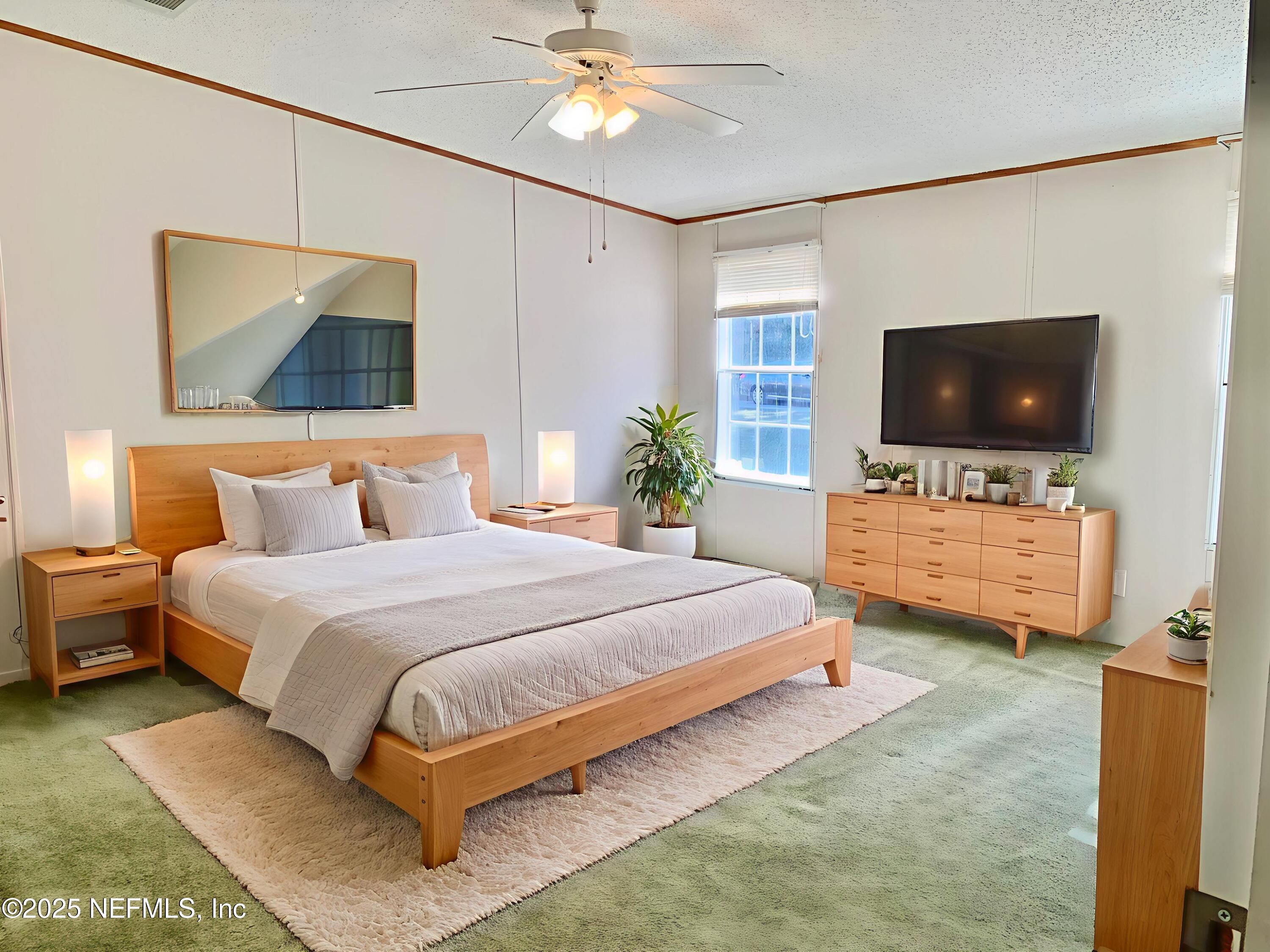 12752 Southeast 9th Place Gainesville, FL 32641 - Photo 20 of 53 a spacious bedroom with a bed and flat screen tv