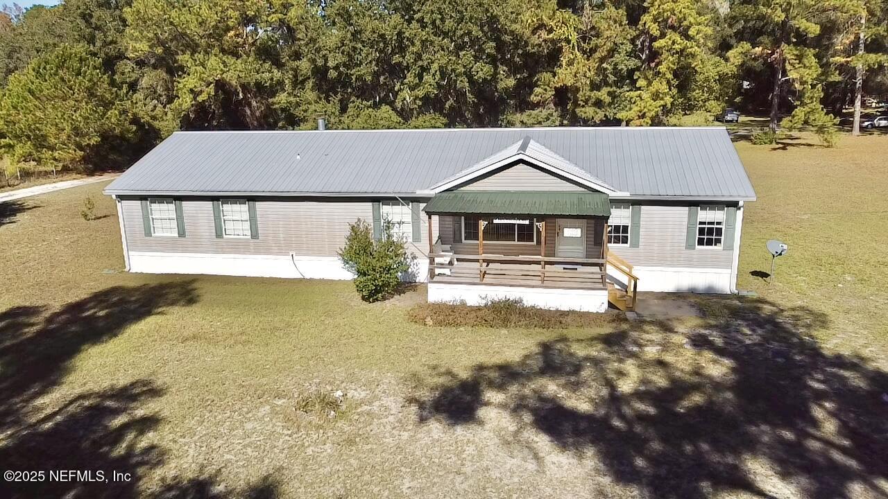 12752 Southeast 9th Place Gainesville, FL 32641 - Photo 49 of 53 a house view with a swimming pool next to a yard