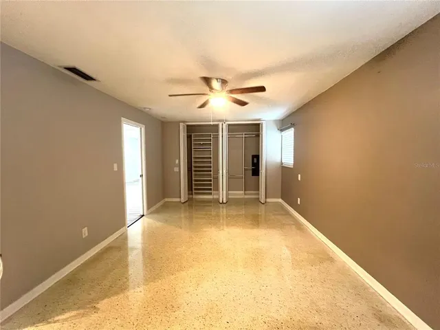 a view of a livingroom with a ceiling fan and window