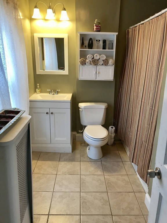 15 Strong Street Springfield, MA 01104 - Photo 12 of 28 a bathroom with a toilet a sink and mirror