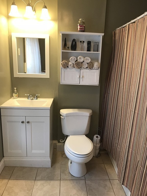 15 Strong Street Springfield, MA 01104 - Photo 13 of 28 a bathroom with a toilet a sink and mirror