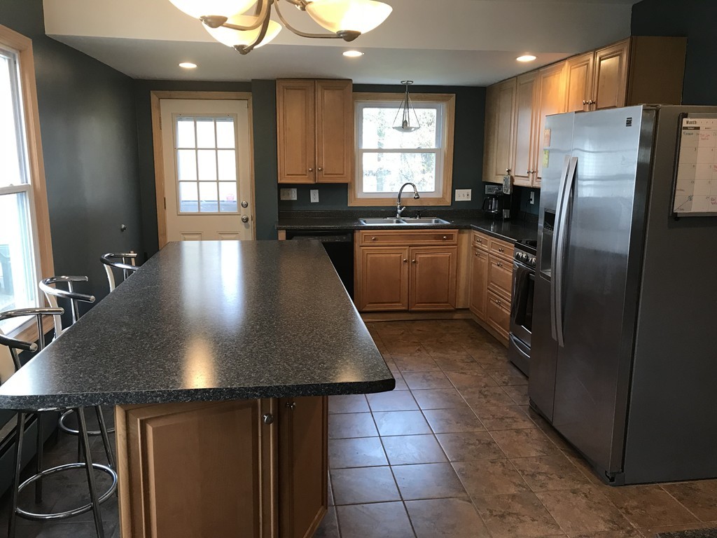 15 Strong Street Springfield, MA 01104 - Photo 3 of 28 a kitchen with stainless steel appliances granite countertop a sink a stove a refrigerator and island