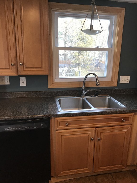 15 Strong Street Springfield, MA 01104 - Photo 5 of 28 a kitchen with a sink a window and cabinets
