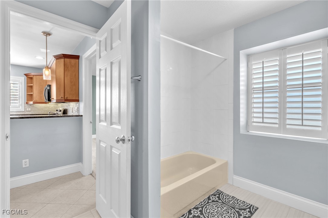 1526 Trafalgar Lane, Unit B Naples, FL 34116 - Photo 12 of 33 a bathroom with a tub shower and a sink