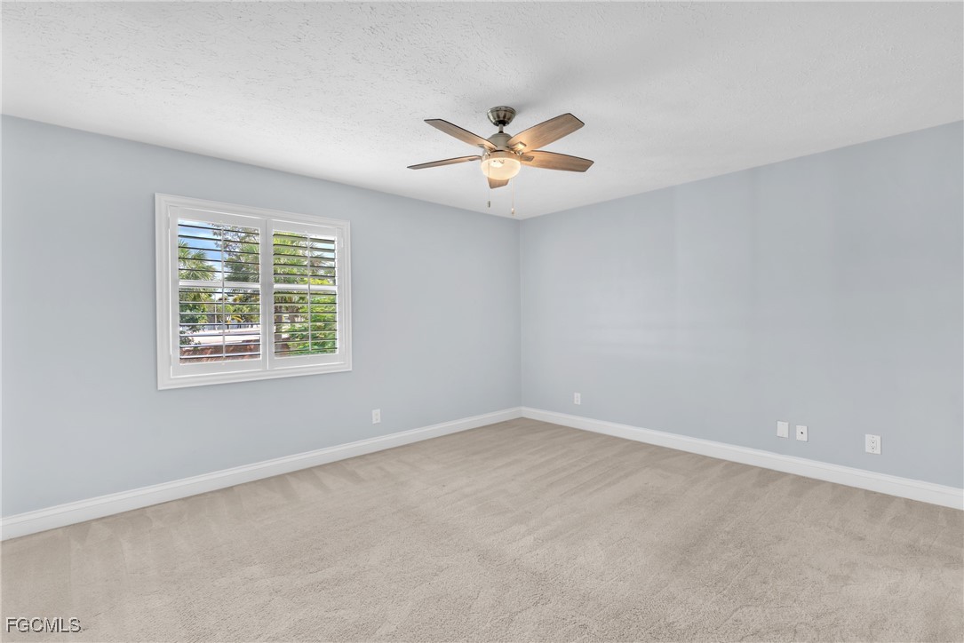 1526 Trafalgar Lane, Unit B Naples, FL 34116 - Photo 15 of 33 an empty room with a window and a fan