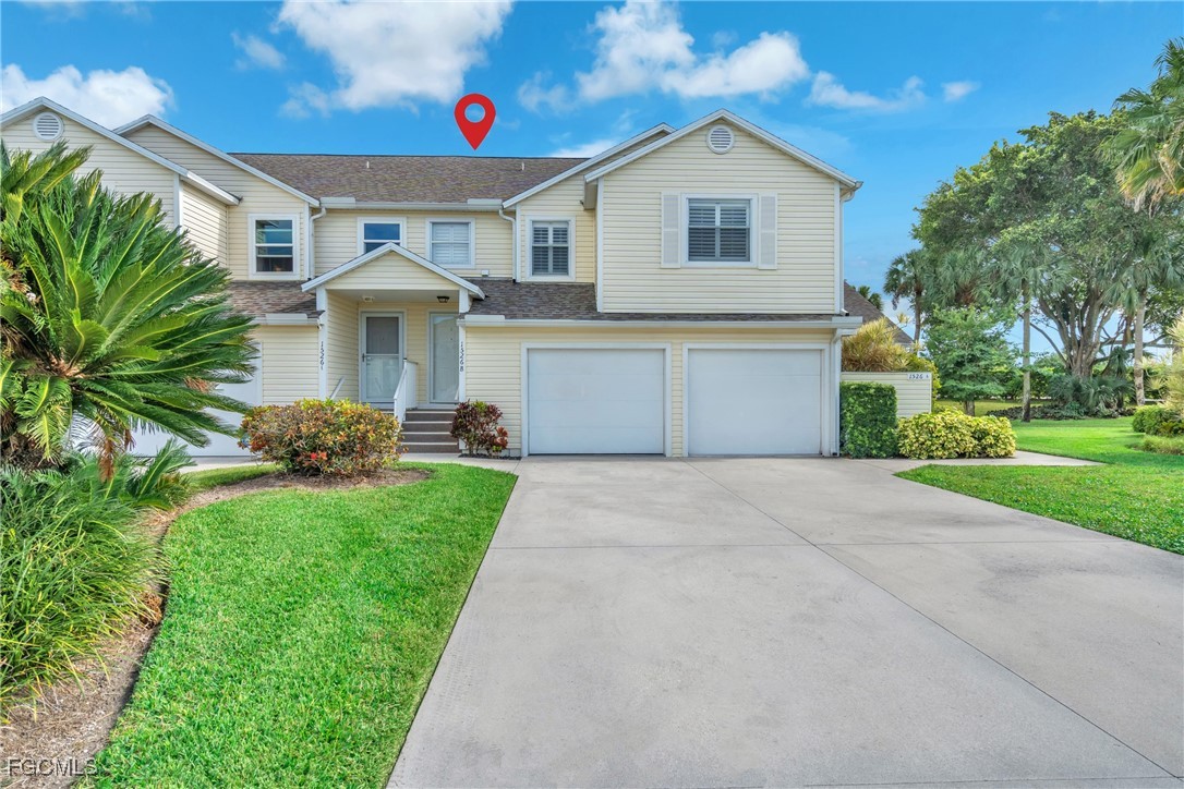 1526 Trafalgar Lane, Unit B Naples, FL 34116 - Photo 2 of 33 a front view of house with yard and green space