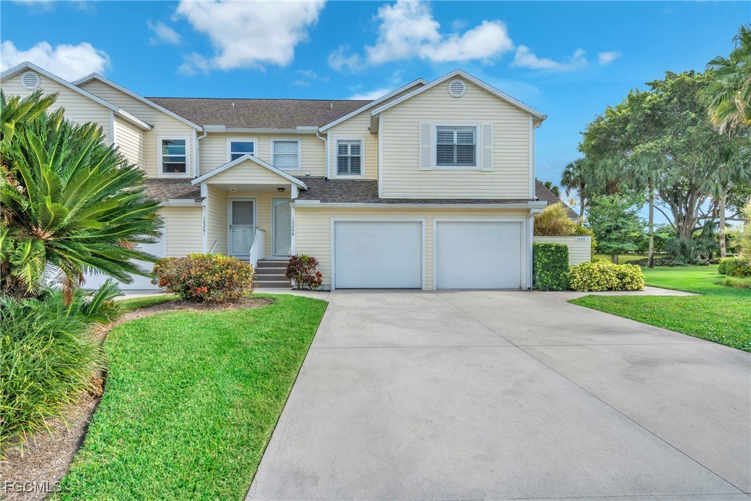 1526 Trafalgar Lane, Unit B Naples, FL 34116 - Photo 3 of 33 a front view of house with yard and green space