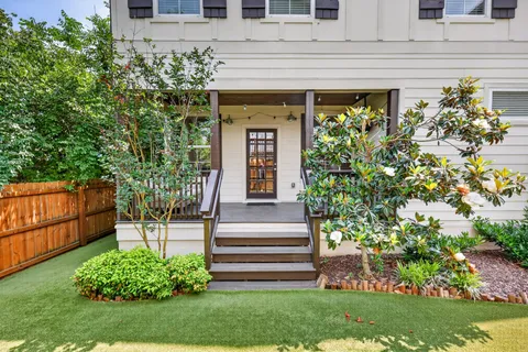 a front view of a house with a garden