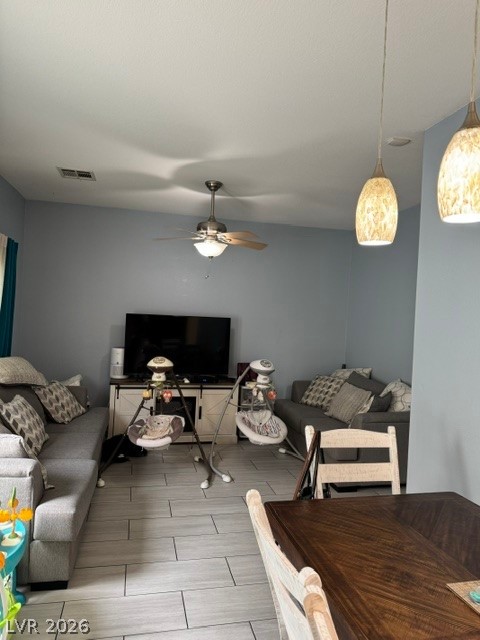 5171 Piazza Cavour Drive Las Vegas, NV 89156 - Photo 13 of 13 An open floorplan offers a seamless transition between living and dining areas, illuminated by a contemporary ceiling fan and stylish pendant lights.