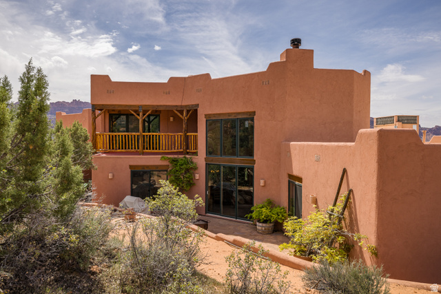 3617 Red Rock Drive Moab, UT 84532 - Photo 9 of 79 Rear view of property featuring a balcony, stucco siding, and a patio area