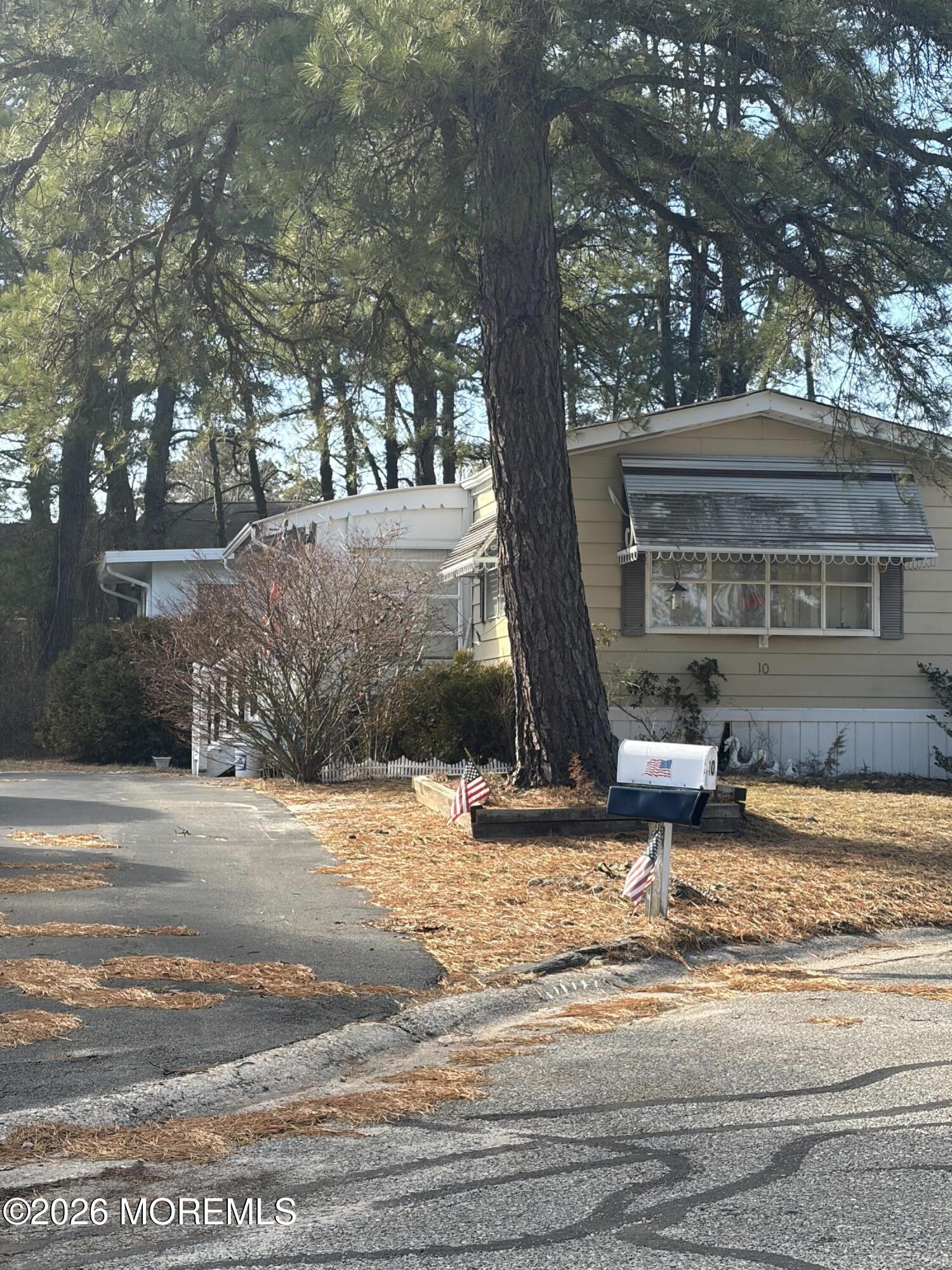a view of a house with snow on the tree