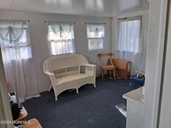 a living room with furniture a window and gym equipment