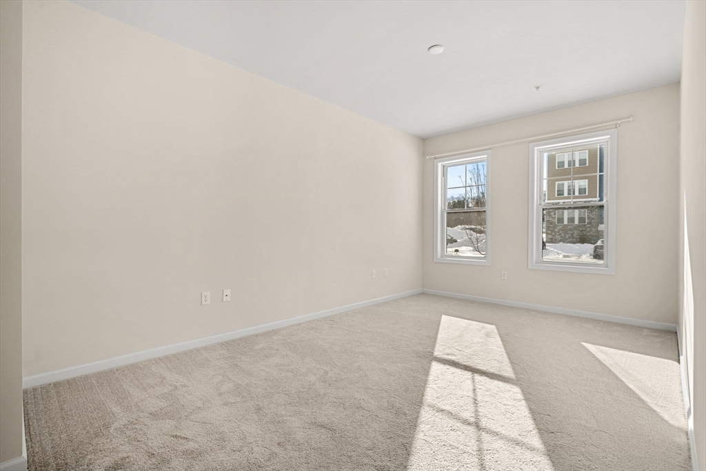 2 Stratton Drive, Unit 102 Woburn, MA 01801 - Photo 16 of 32 an empty room with windows