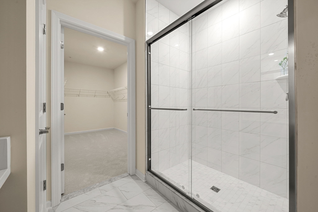 2 Stratton Drive, Unit 102 Woburn, MA 01801 - Photo 19 of 32 a bathroom with a glass shower door