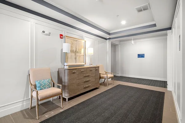 a view of a room with wooden floor and electronic appliances