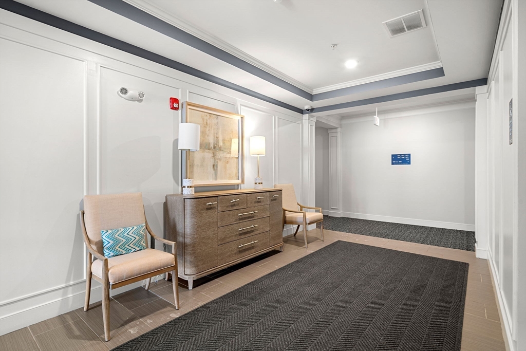 2 Stratton Drive, Unit 102 Woburn, MA 01801 - Photo 29 of 32 a room with furniture and a window