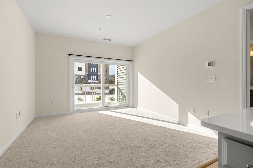 2 Stratton Drive, Unit 102 Woburn, MA 01801 - Photo 6 of 32 a view of an empty room with a window