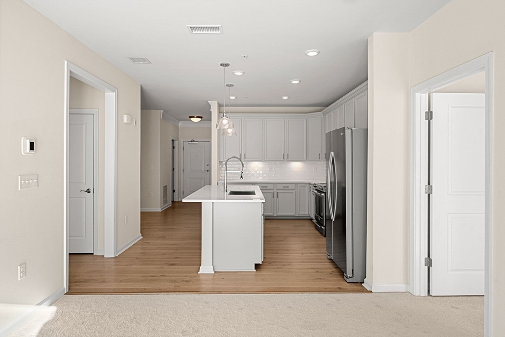 2 Stratton Drive, Unit 102 Woburn, MA 01801 - Photo 7 of 32 a view of kitchen with wooden floor