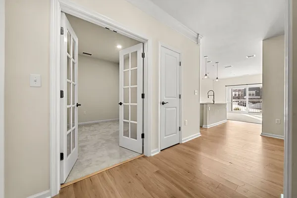 a view of a hallway with wooden floor