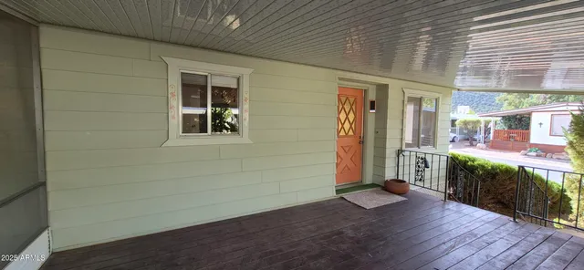 a view of an empty room with window and cabinet