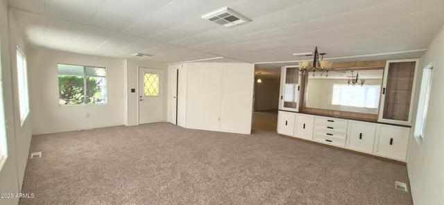 a view of a dining room with furniture a chandelier and wooden floor
