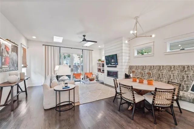 a kitchen with a dining table chairs sink and white cabinets