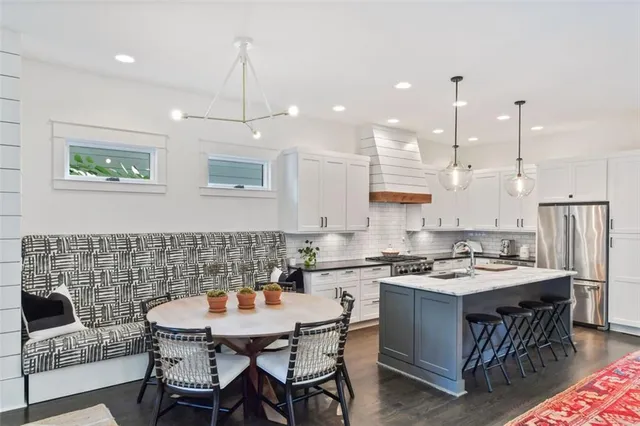 a living room with furniture kitchen view and a fireplace