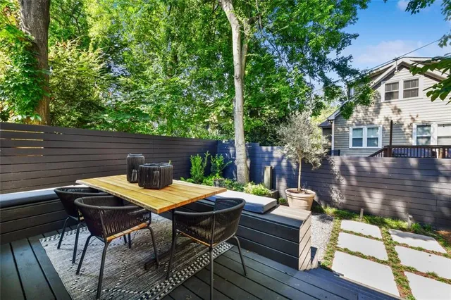 a view of a patio with couches table and chairs and potted plants