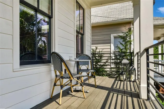 a view of balcony with two chairs and a potted plant