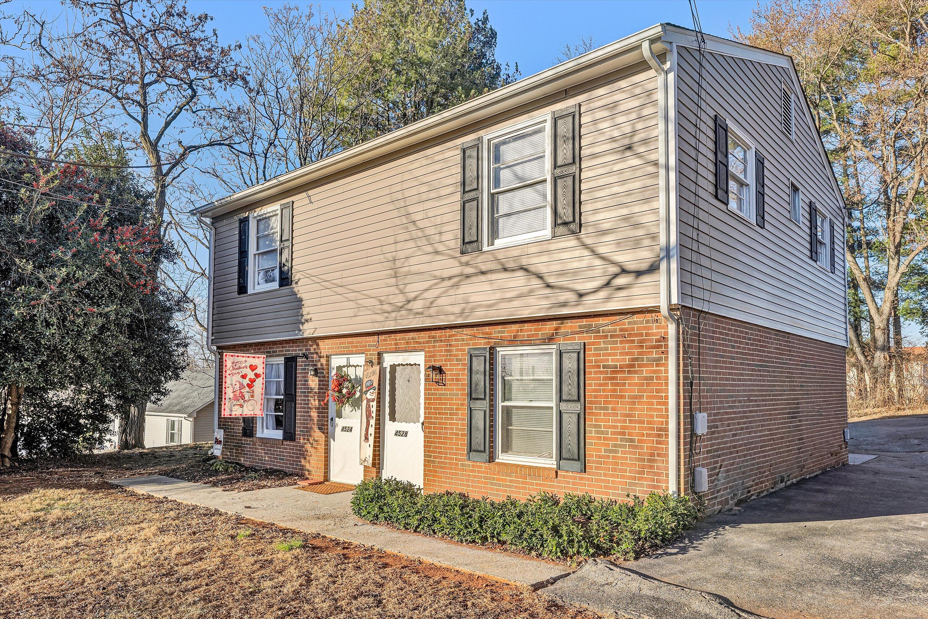 4524 Ohio Street Northeast, Unit 4528 Roanoke, VA 24019 - Photo 2 of 28 a front view of a house with a yard and garage