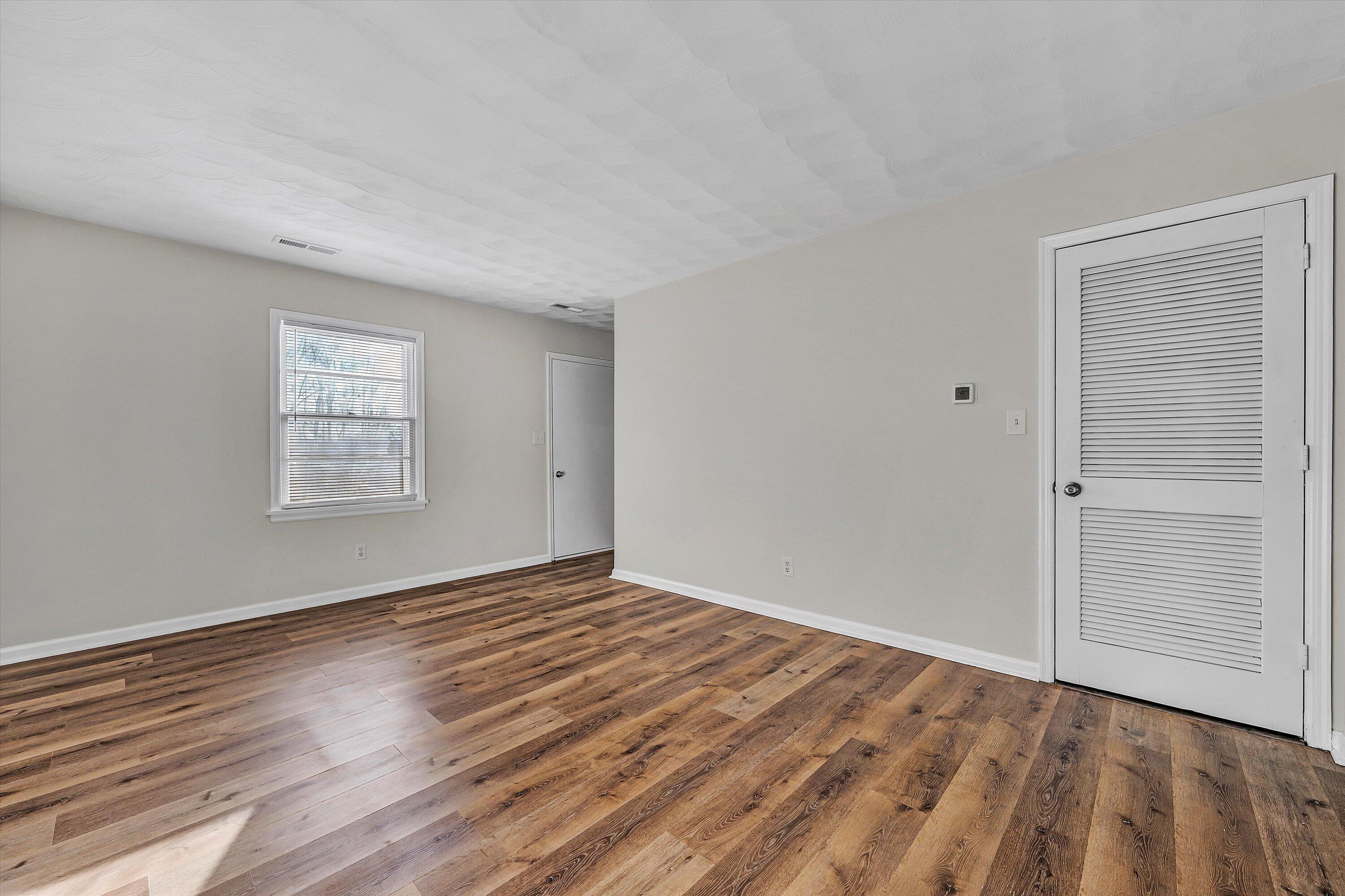 4524 Ohio Street Northeast, Unit 4528 Roanoke, VA 24019 - Photo 8 of 28 a view of an empty room with wooden floor and a window