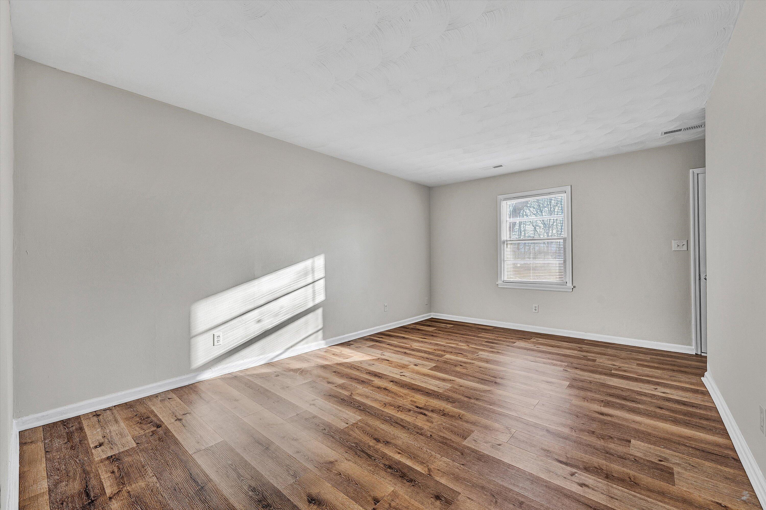 4524 Ohio Street Northeast, Unit 4528 Roanoke, VA 24019 - Photo 9 of 28 a view of an empty room with wooden floor and a window