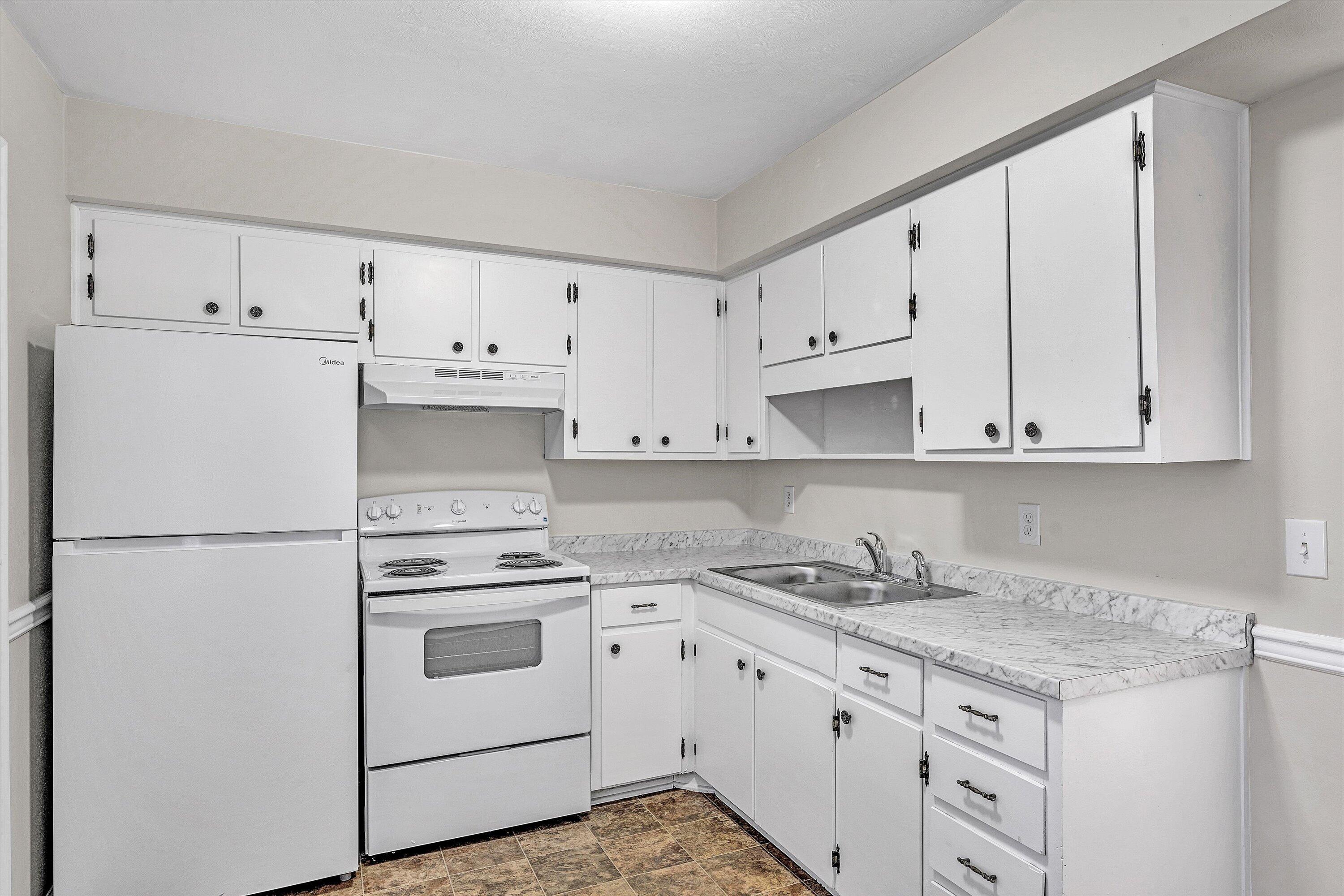 4524 Ohio Street Northeast, Unit 4528 Roanoke, VA 24019 - Photo 10 of 28 a kitchen with granite countertop white cabinets and white appliances