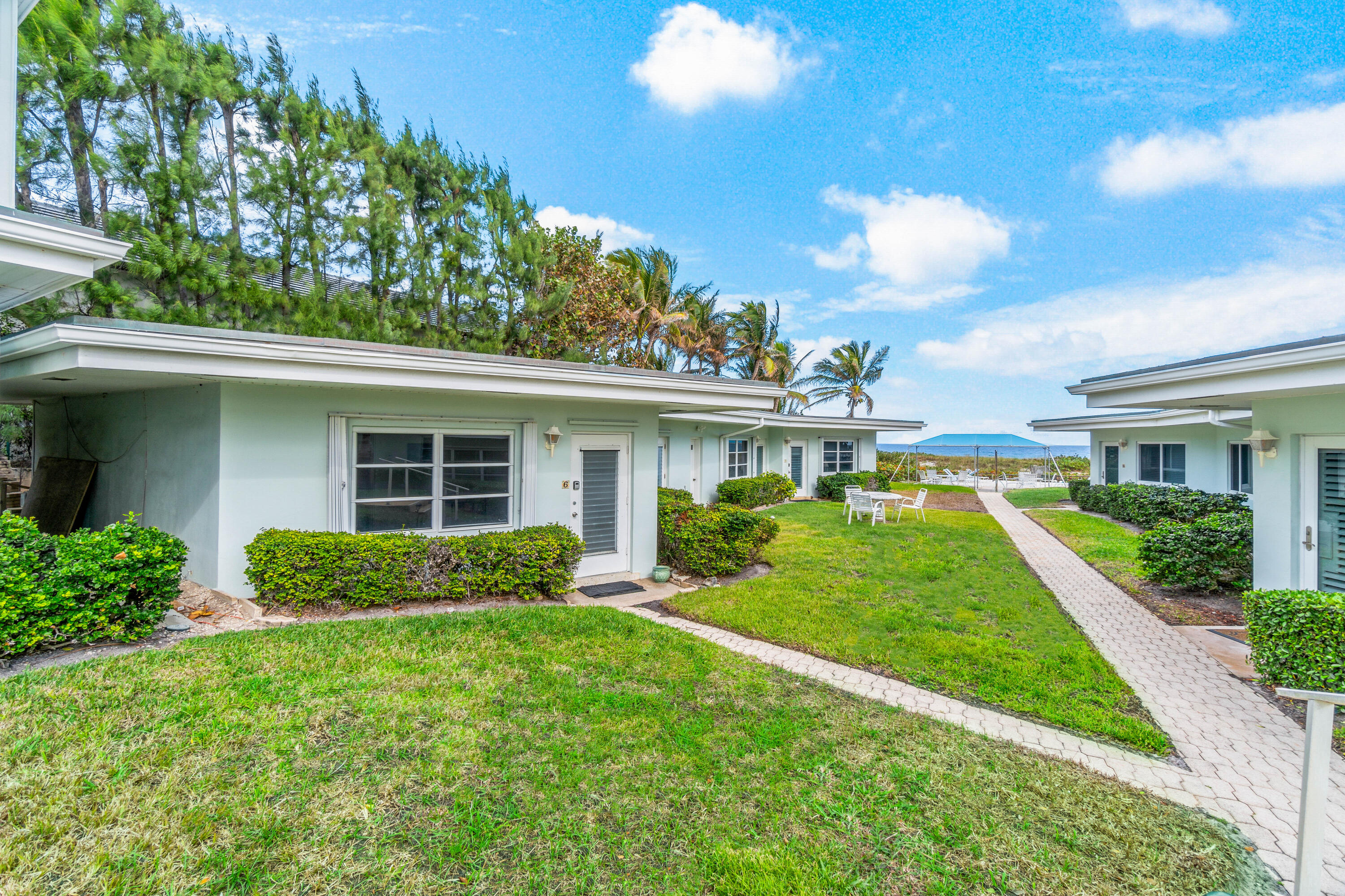 1191 South Ocean Boulevard, Unit 6 Delray Beach, FL 33483 - Photo 1 of 19 front view of a house with a yard