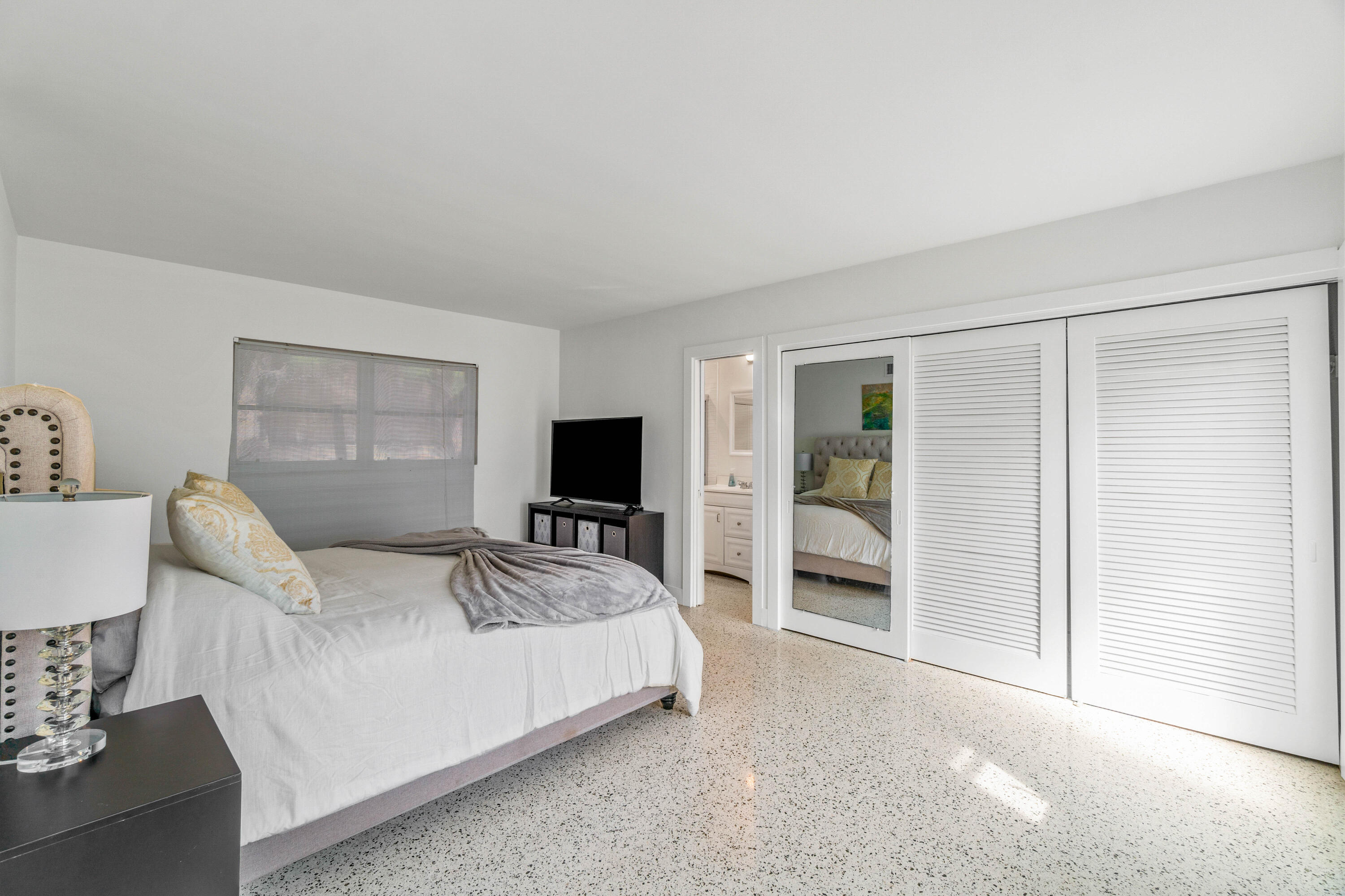 1191 South Ocean Boulevard, Unit 6 Delray Beach, FL 33483 - Photo 12 of 19 a bedroom with a bed and a flat screen tv