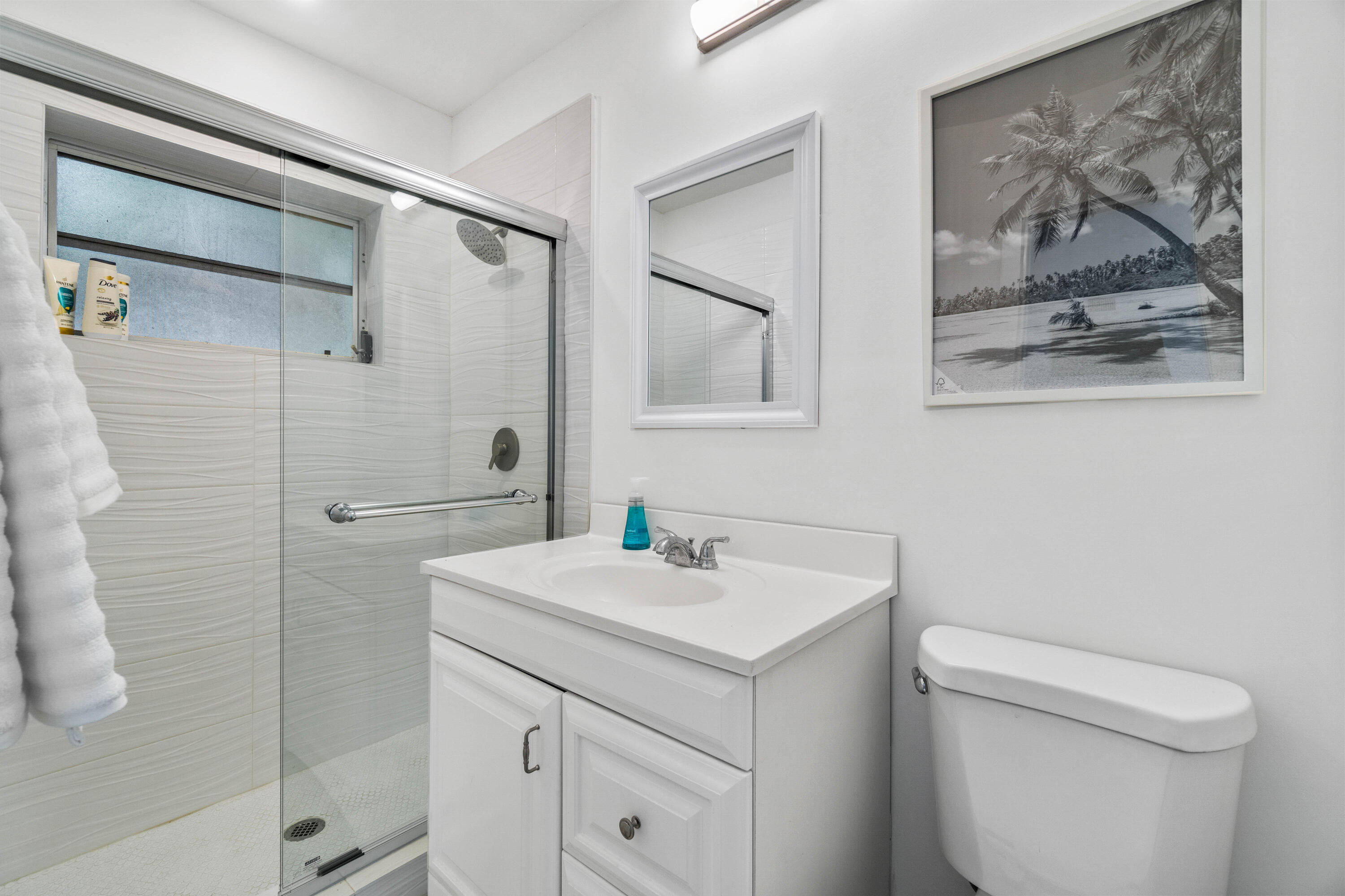 1191 South Ocean Boulevard, Unit 6 Delray Beach, FL 33483 - Photo 14 of 19 a bathroom with a sink mirror vanity and toilet