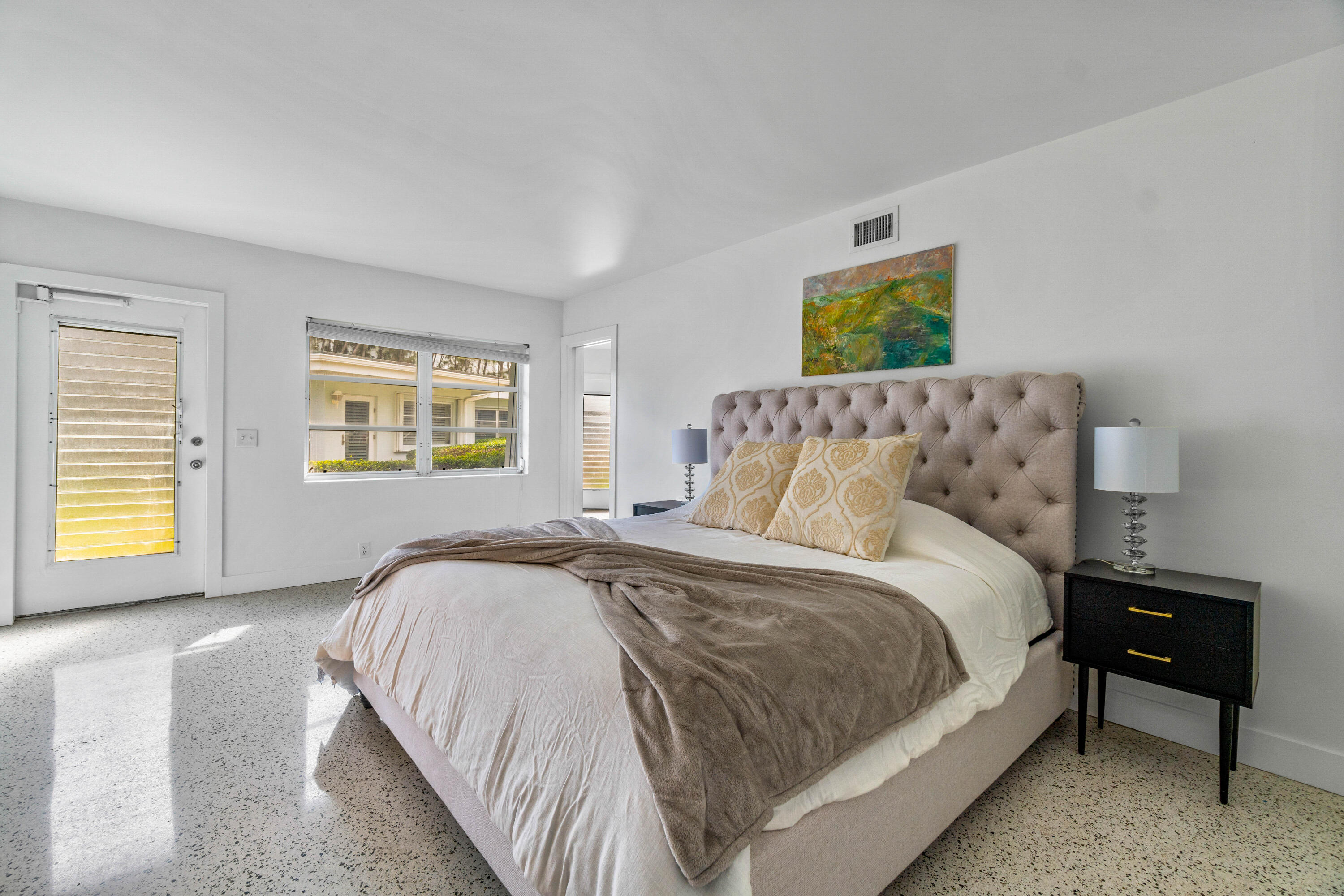 1191 South Ocean Boulevard, Unit 6 Delray Beach, FL 33483 - Photo 15 of 19 a spacious bedroom with a bed and a window