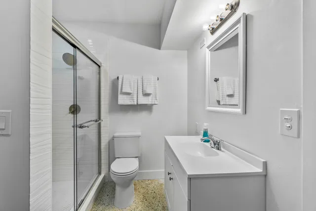 a bathroom with a sink toilet and shower