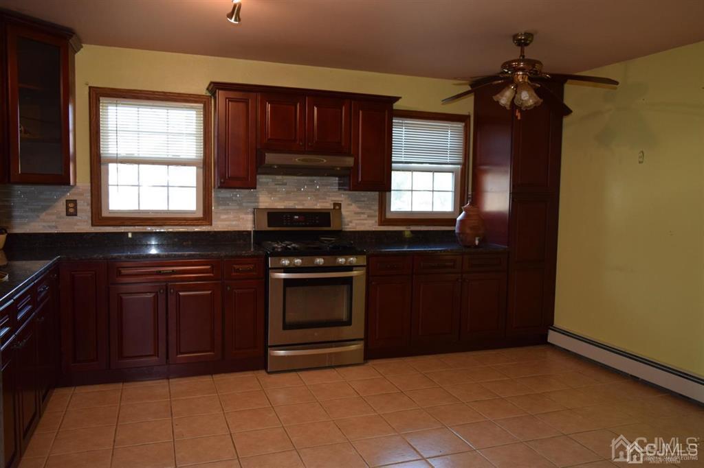 11 Post Boulevard Carteret, NJ 07008 - Photo 11 of 23 a kitchen with a sink stove and microwave