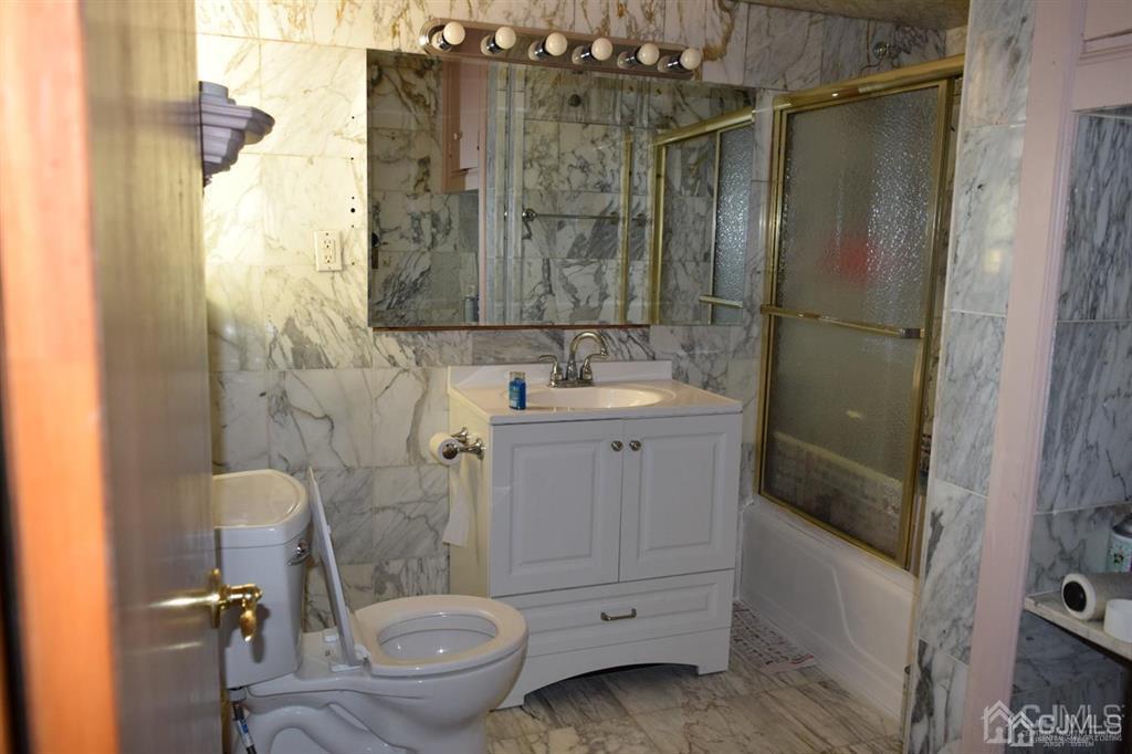 11 Post Boulevard Carteret, NJ 07008 - Photo 12 of 23 a bathroom with a granite countertop sink toilet and shower