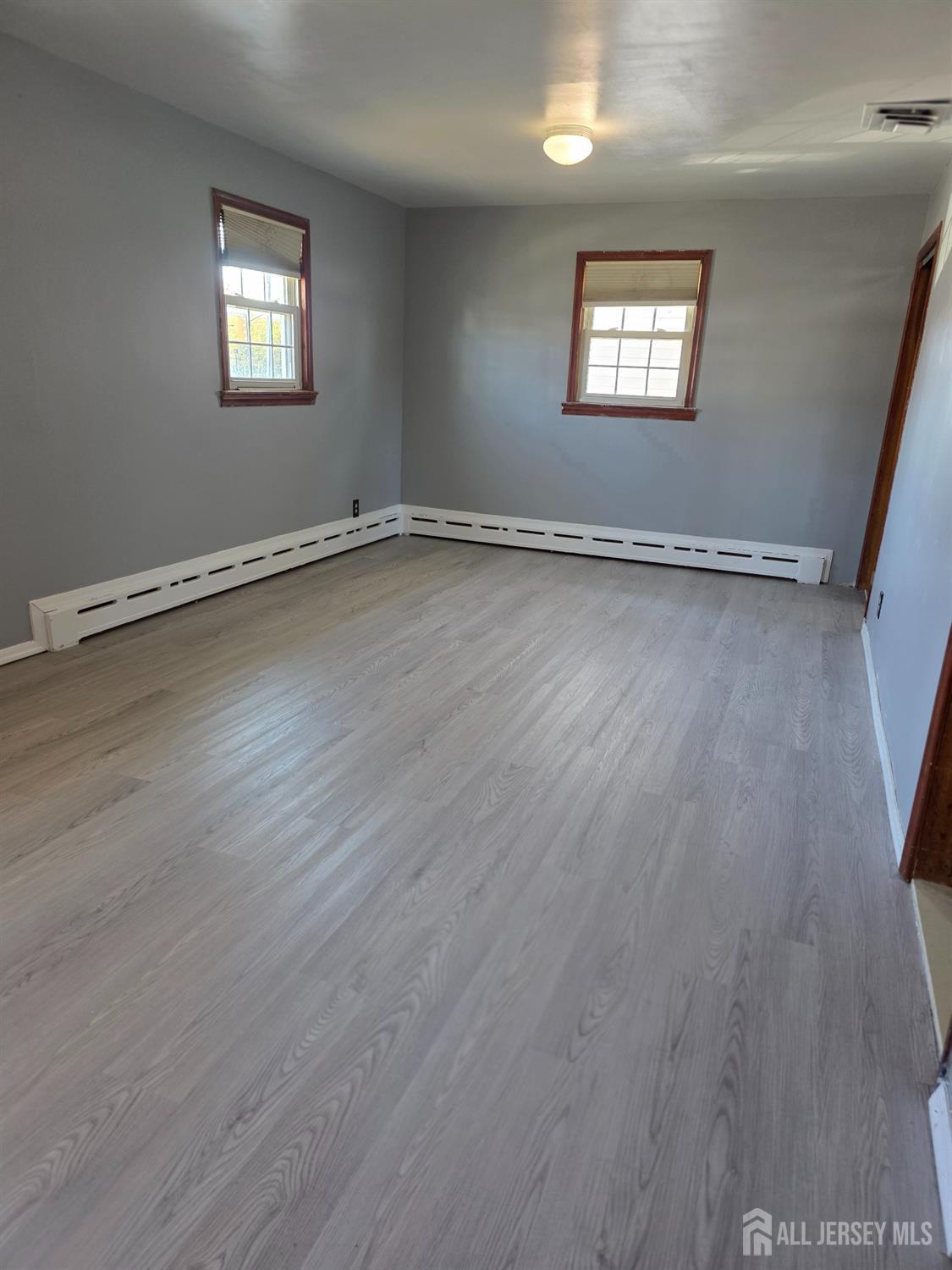 11 Post Boulevard Carteret, NJ 07008 - Photo 14 of 23 an empty room with wooden floor and windows