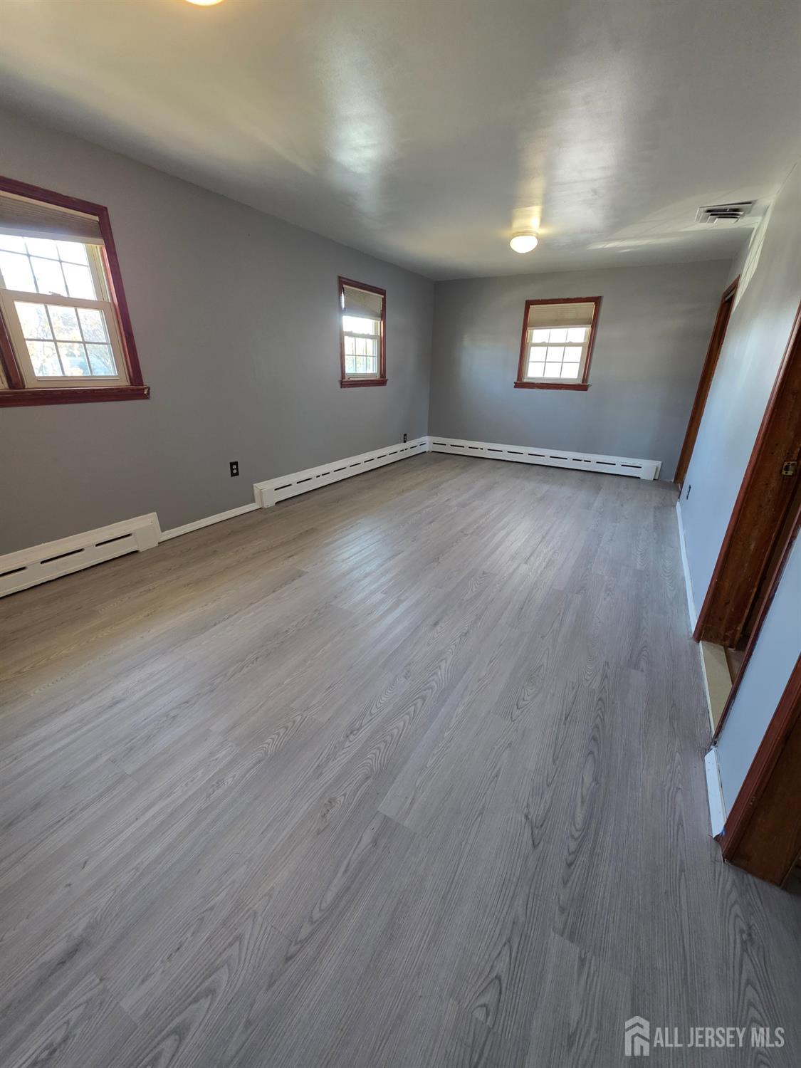 11 Post Boulevard Carteret, NJ 07008 - Photo 15 of 23 a view of an empty room with wooden floor and a window