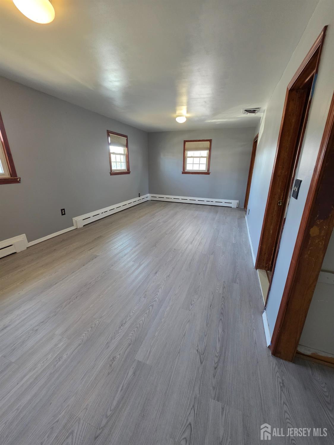 11 Post Boulevard Carteret, NJ 07008 - Photo 16 of 23 an empty room with wooden floor and windows