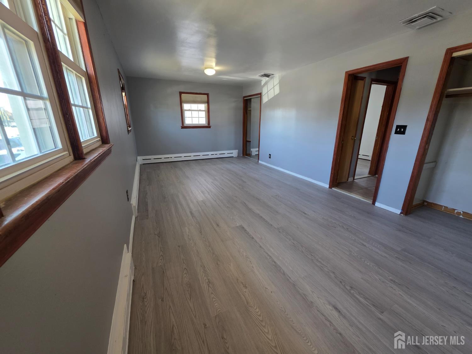 11 Post Boulevard Carteret, NJ 07008 - Photo 17 of 23 a view of an empty room with wooden floor and a window