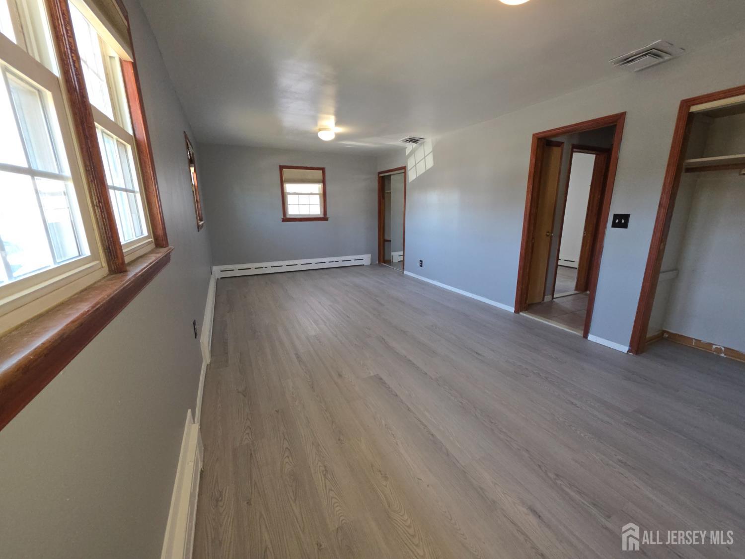 11 Post Boulevard Carteret, NJ 07008 - Photo 18 of 23 a view of an empty room with wooden floor and a window