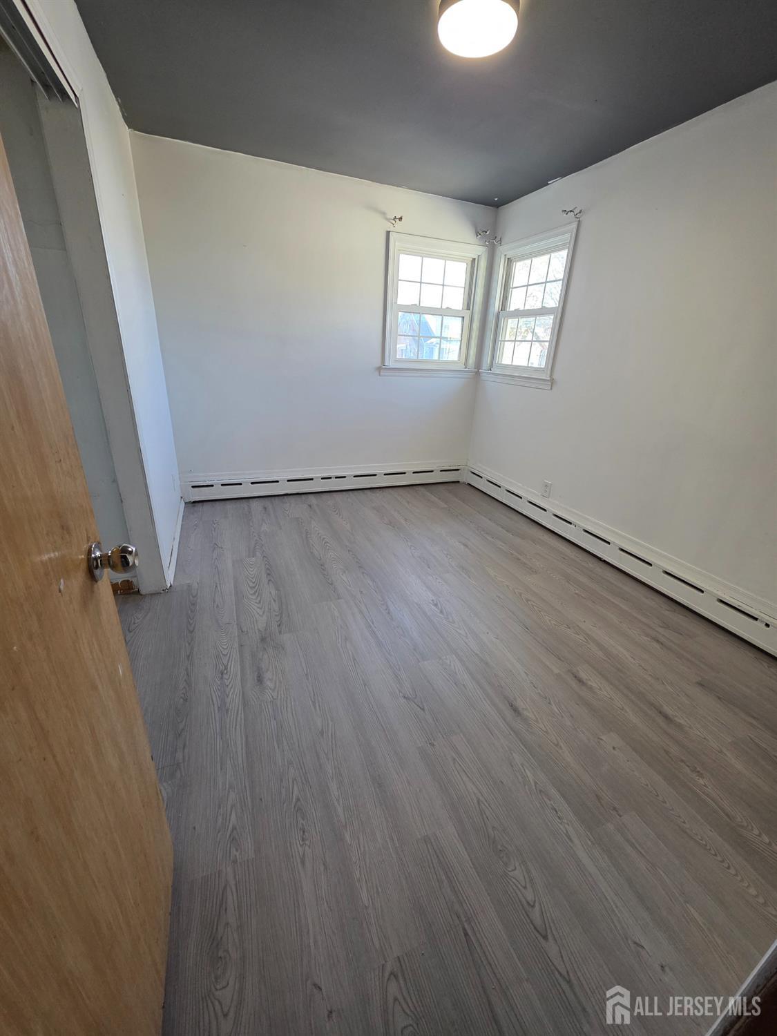 11 Post Boulevard Carteret, NJ 07008 - Photo 19 of 23 a view of a room with wooden floor and windows