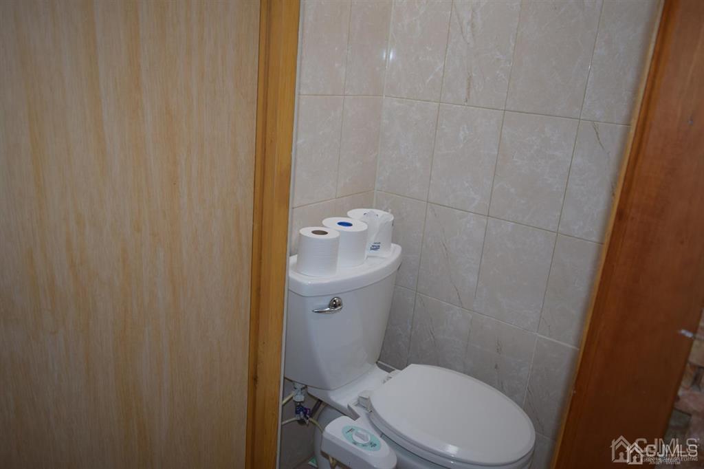 11 Post Boulevard Carteret, NJ 07008 - Photo 22 of 23 a white toilet sitting next to a shower curtain