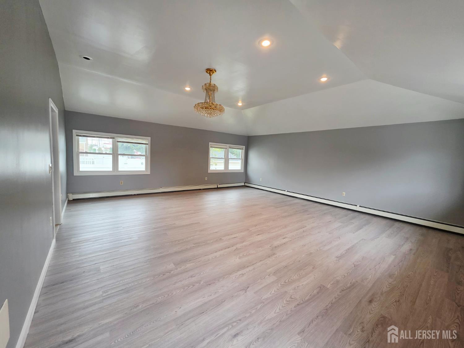 11 Post Boulevard Carteret, NJ 07008 - Photo 4 of 23 an empty room with wooden floor and windows