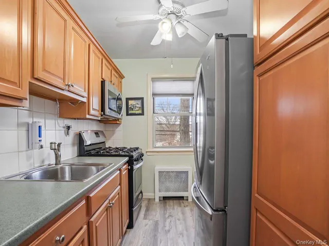 a kitchen with stainless steel appliances a stove a sink and a cabinets