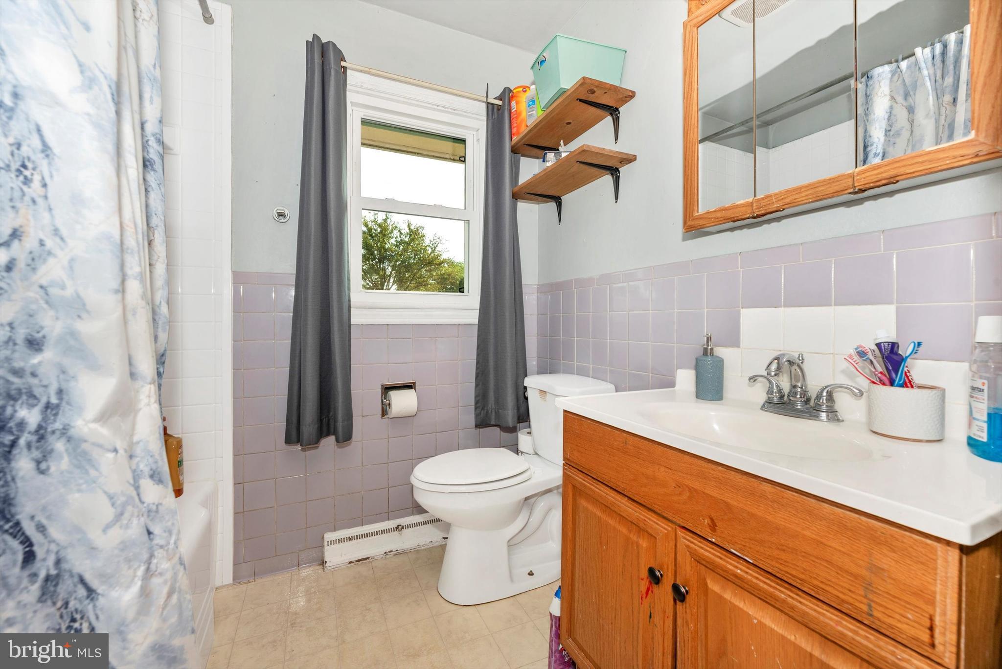 21 Harvard Road Hagerstown, MD 21742 - Photo 8 of 10 a bathroom with a sink a toilet and a shower curtain